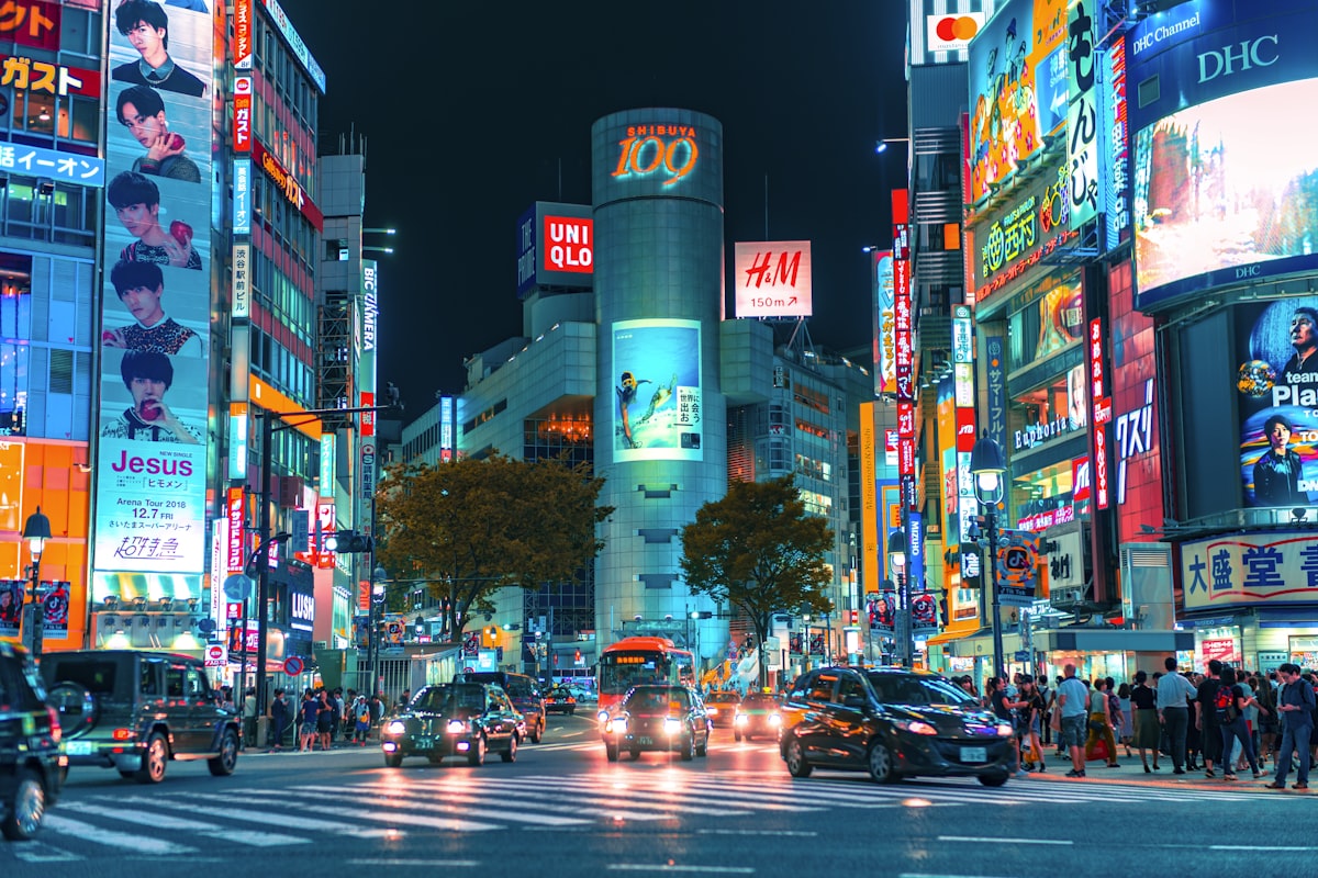 Busy pedestrian crossing in Tokyo with colorful buildings