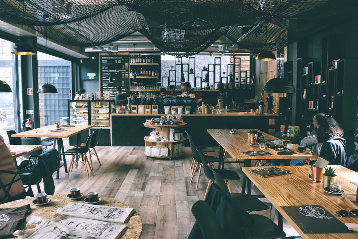 Person working on laptop at a bright cafe